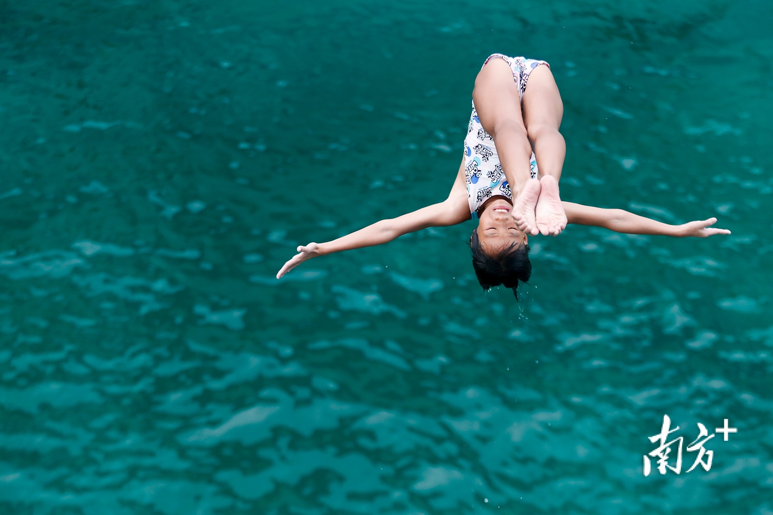 在汕头体校的水上训练池，一名女学员在七米跳台一跃而下。