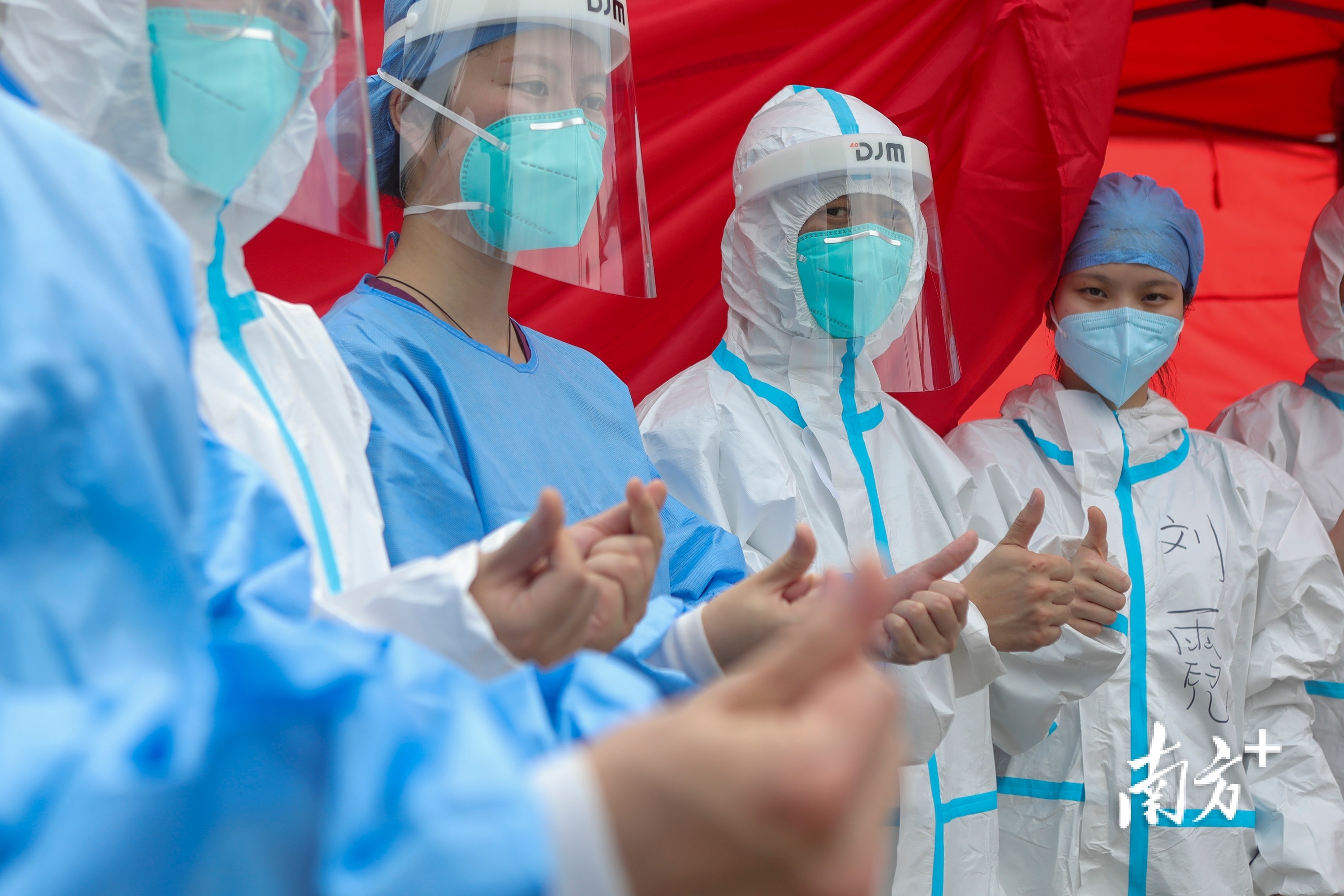 在深圳市龙岗区上雪科技园核酸检测点，换班的医护人员互相鼓励打气。南方日报记者 朱洪波 摄